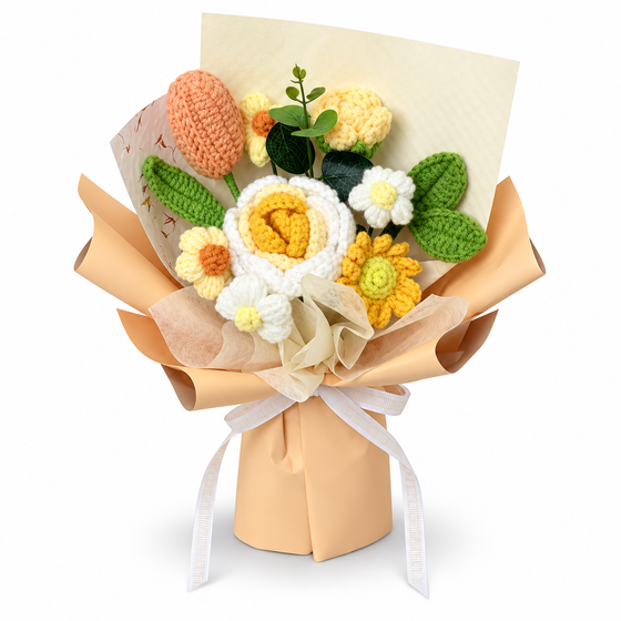 Yellow and white crochet flower bouquet with a peach-colored bud, green leaves, peach wrapping and a pale ribbon
